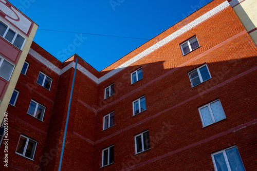 Facade of an apartment building against the blue sky