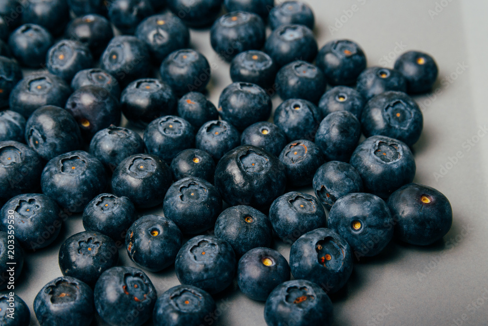 large, fresh blueberries lie on a gray plate, close-up large, fresh blueberries lie on a gray plate, close-up