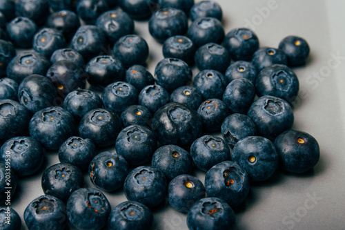 large  fresh blueberries lie on a gray plate  close-up