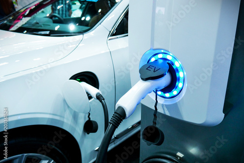 Power supply connect to electric vehicle for charge to the battery. Charging technology industry transport which are the futuristic of the Automobile.EV fuel Plug in hybrid car. photo