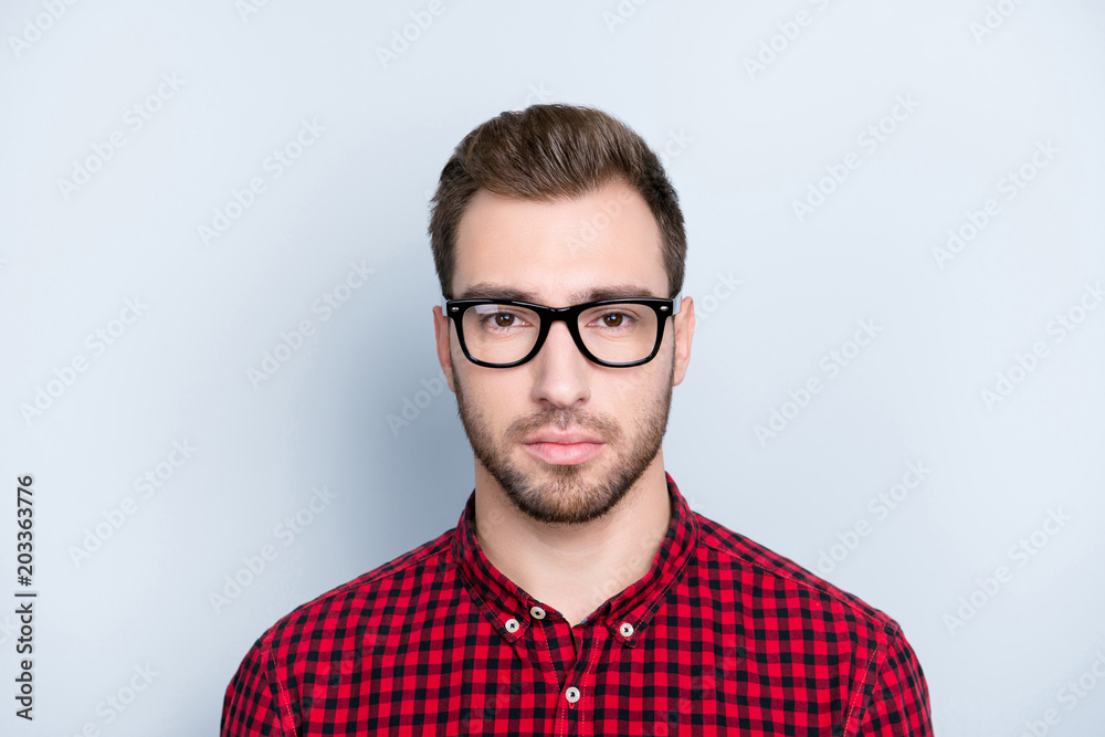 Close up portrait of strict serious confident concentrated experienced qualified master expert wearing red checkered shirt and glasses, isolated om gray background