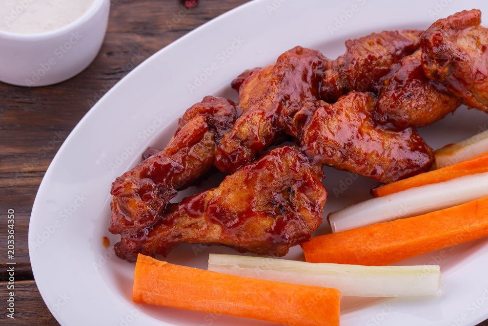 Chicken wings in tomato sauce with vegetables Chicken wings in tomato sauce with vegetables