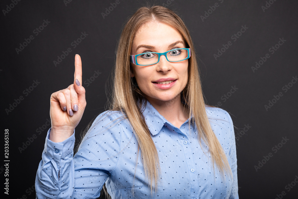 Business lady wearing blue glasses posing having idea. Business lady wearing blue glasses posing having idea.