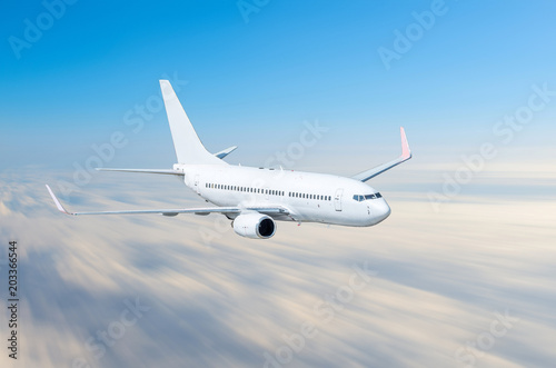 Airplane in the sky above the clouds flight journey sun height speed motion blur.