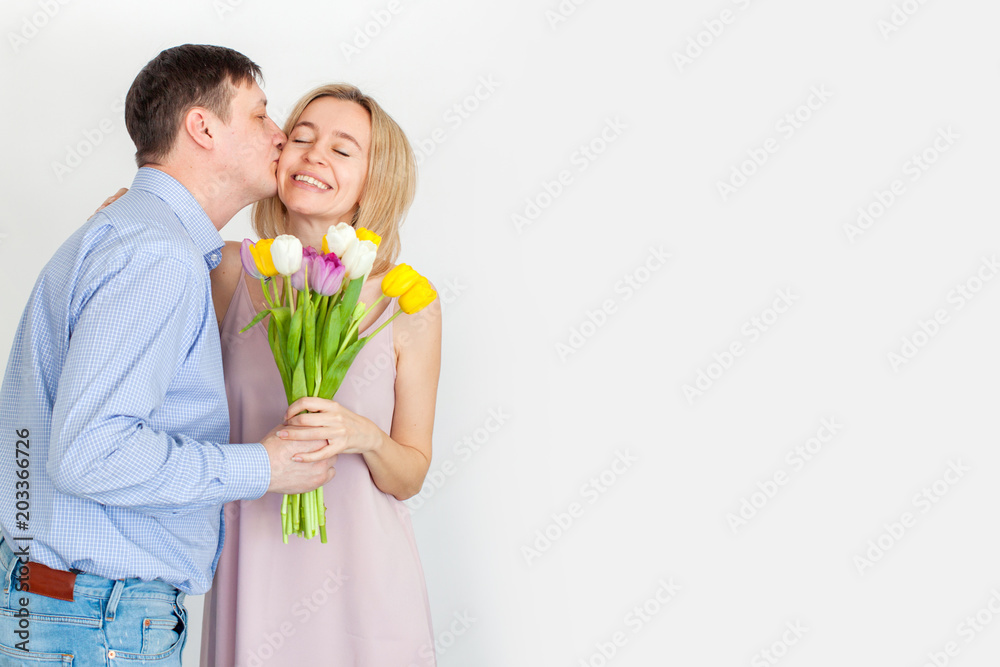 Man gives a bouquet of flowers to woman Man gives a bouquet of flowers to woman