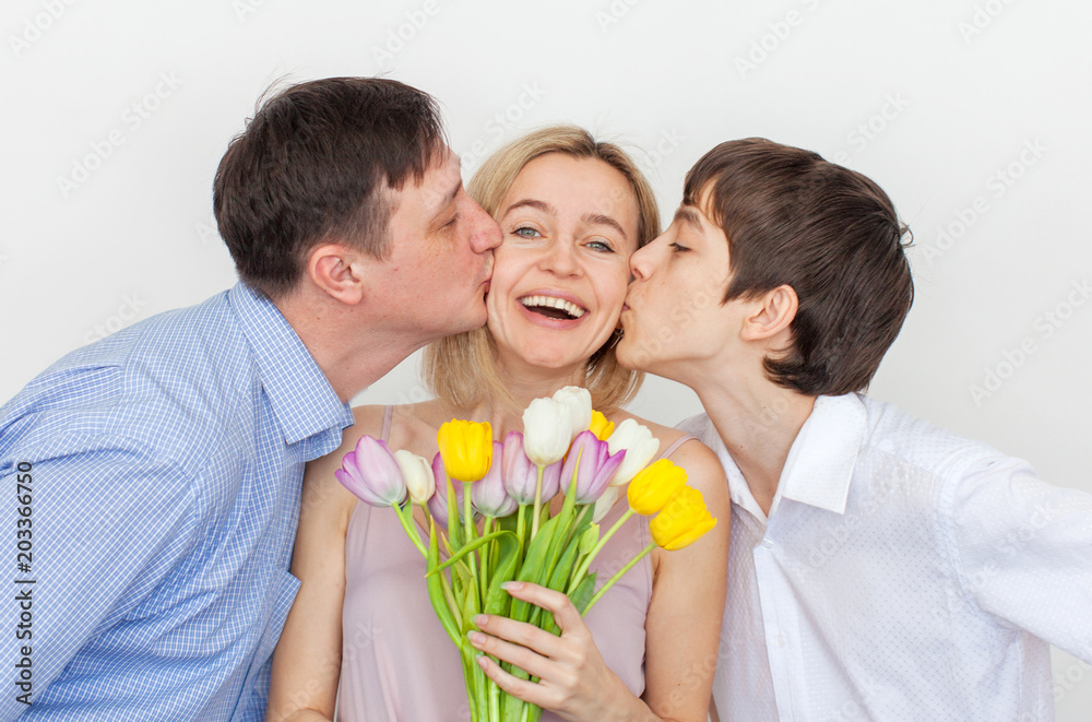 Man and son gives a bouquet of flowers to woman Man and son gives a bouquet of flowers to woman