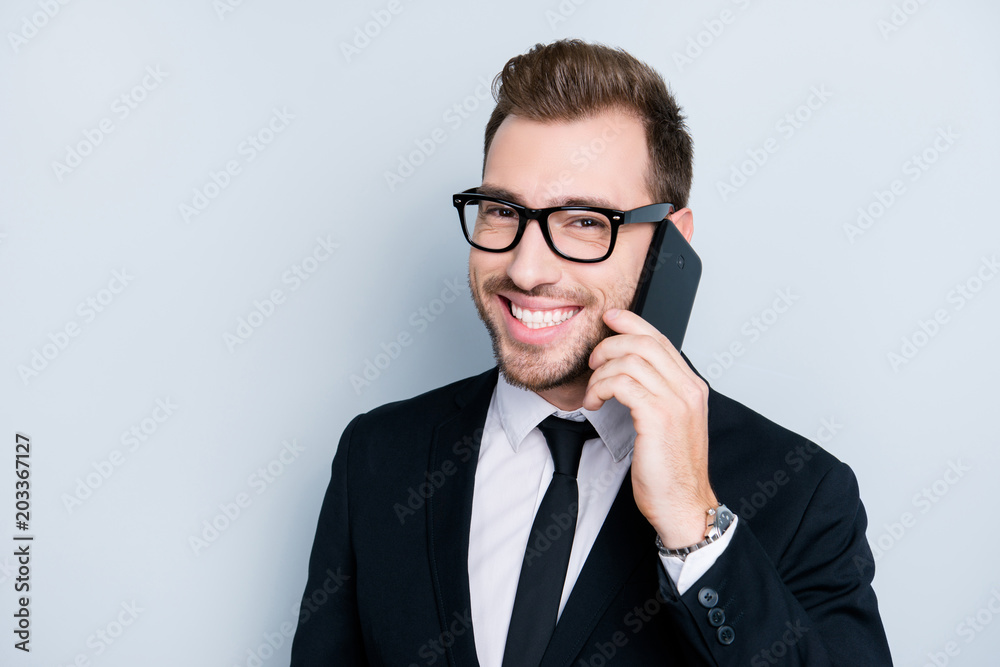 Close up portrait of excited joyful smart clever intelligent self-empyoed man wearing formal outfit, he is talking on phone about organizing meeting with business partners, isolated on gray background Close up portrait of excited joyful smart clever intelligent self-empyoed man wearing formal outfit, he is talking on phone about organizing meeting with business partners, isolated on gray background
