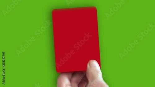 Hand shows red card on green screen