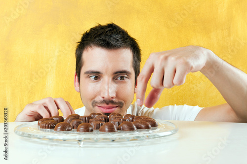 young man reaching for chocolate