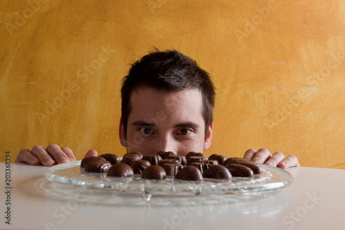 young man looking at the chocolates