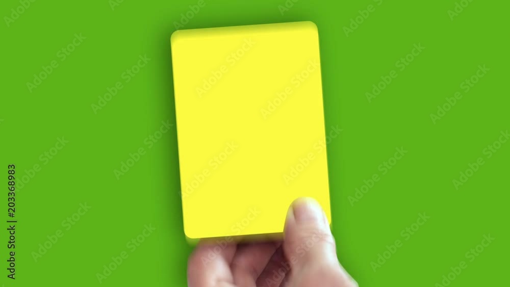 Hand shows yellow card on green screen