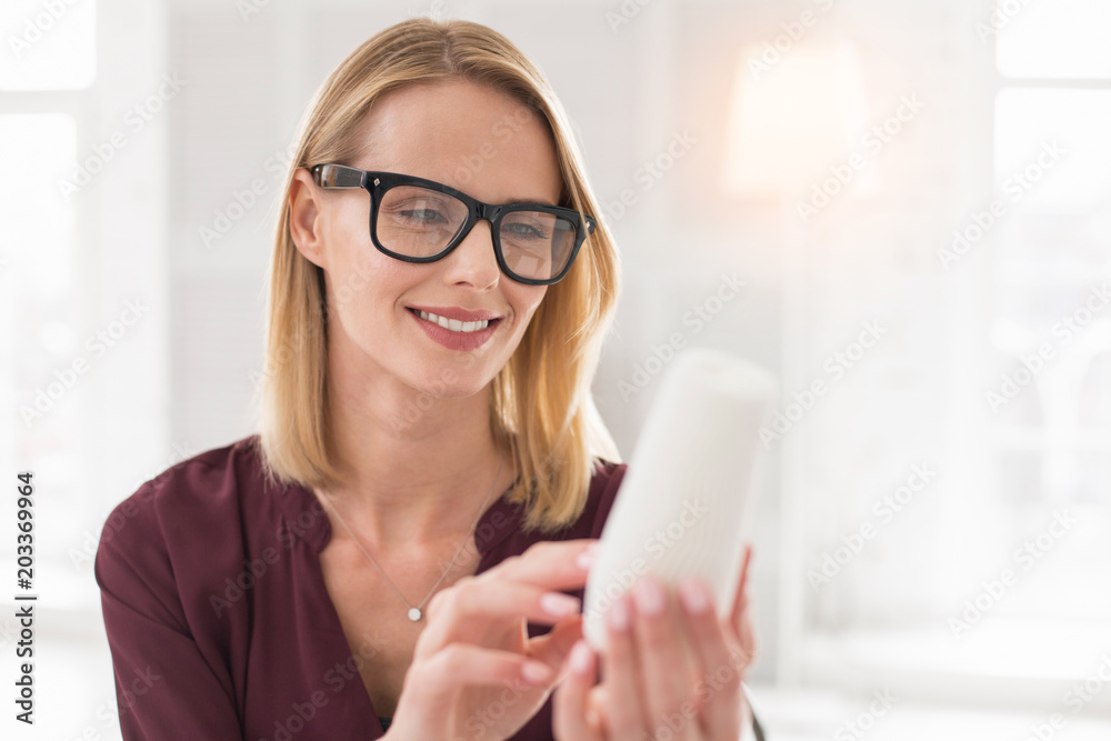 Perfect element. Gay female designer holding sample while wearing glasses Perfect element. Gay female designer holding sample while wearing glasses