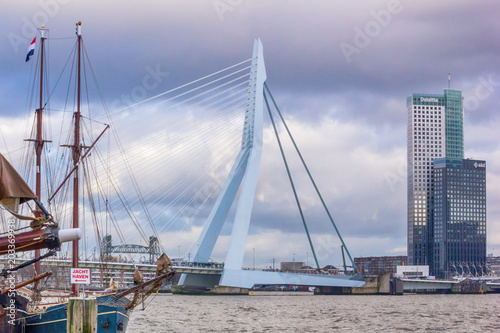 Cityscape - view of the moored sailboat on a background of skyscrapers district Feijenoord city of Rotterdam and the Erasmus Bridge, The Netherlands © rustamank