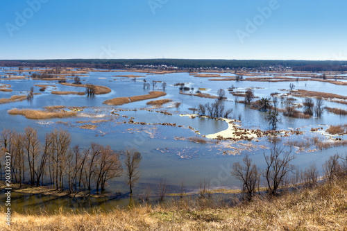 Spring landscape - flood in river valley of the Siverskyi (Seversky) Donets, the winding river over the meadows between hills and forests, the northeast of Ukraine