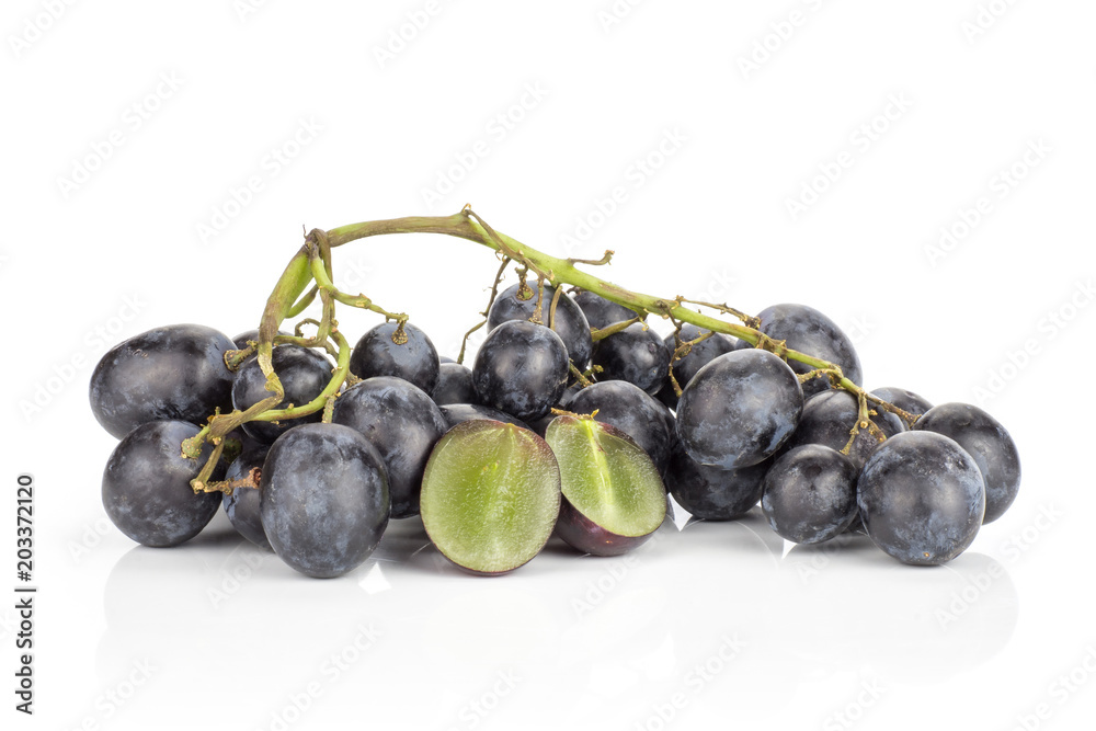 Black grape cluster (autumn royal variety) isolated on white background one purple berry cut in two halves. Black grape cluster (autumn royal variety) isolated on white background one purple berry cut in two halves.