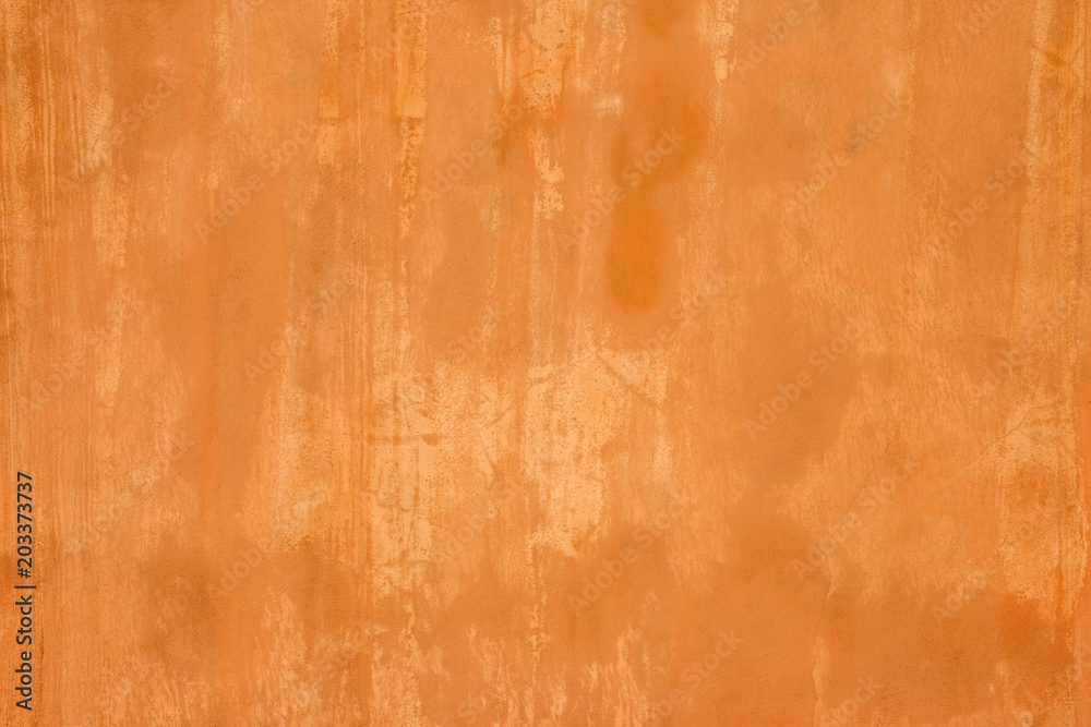 Orange wall texture. Wall painted orange with grunge effect.