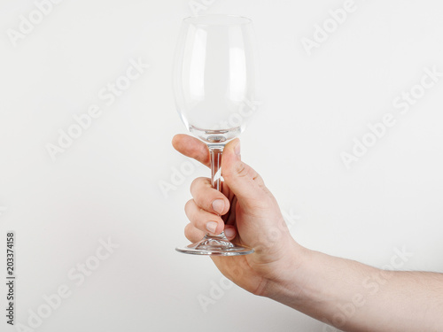 empty glass of wine in hand on a white background