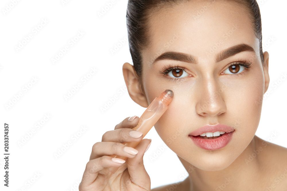 Eye Skin Care. Beautiful Woman Using Cream