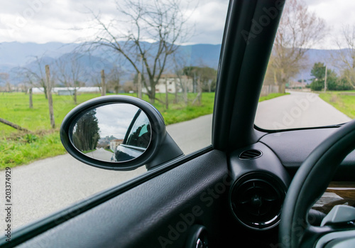 view from inside a car. road reflections on a rear view mirror. travel © MrVettore
