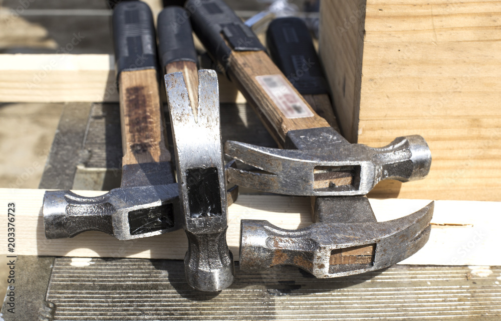 hammers a nail into a wooden log using an old hammer hammers a nail into a wooden log using an old hammer