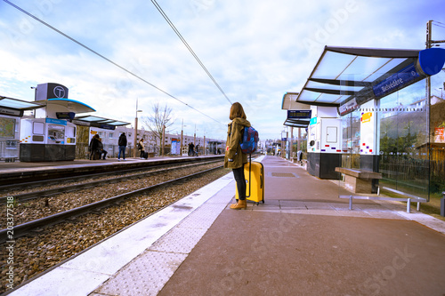 girl tourist  waits for the train