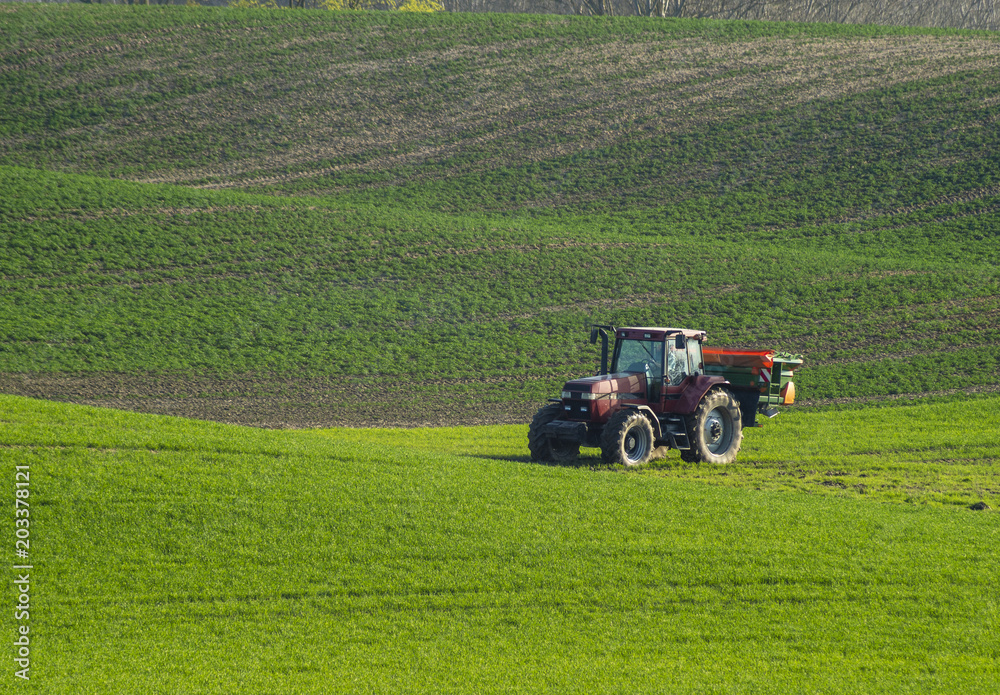 tractor with seeder sowing grain in spring tractor with seeder sowing grain in spring
