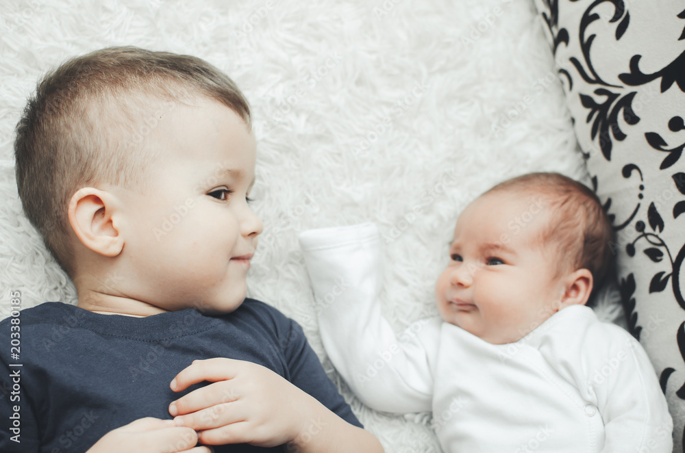 Cute, brother hugs and kisses little sister Cute, brother hugs and kisses little sister