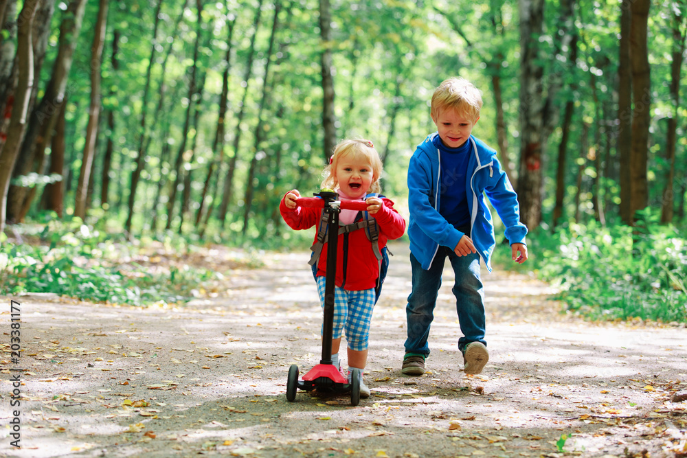 little girl riding scooter and boy running, kids sport little girl riding scooter and boy running, kids sport