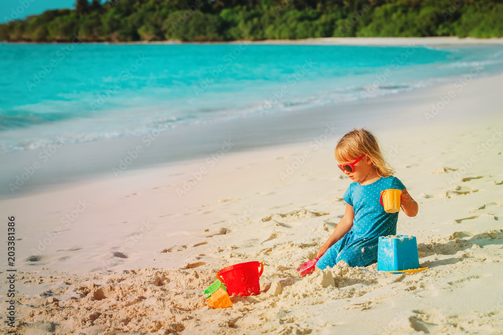 cute little girl play with sand on beach cute little girl play with sand on beach