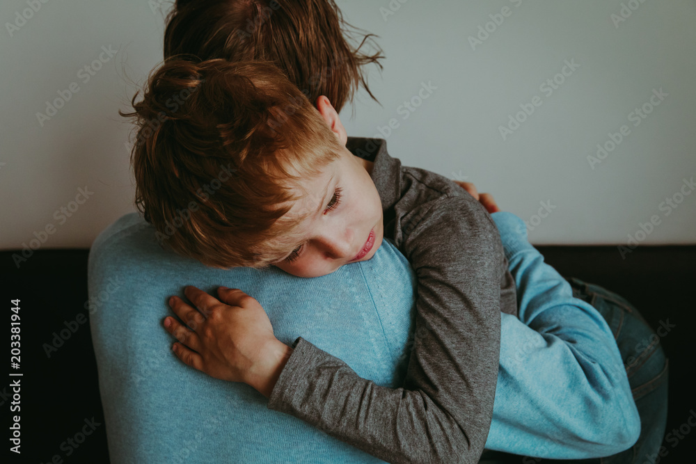 Father comforting sad child, parenting, sorrow