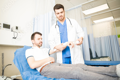 Doctor treating a patient in emergency room