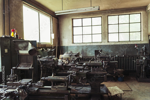 Mechanical workshop/Old metal spare parts workshop with vintage turning machines and tool kits.