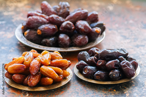 Various of dried dates or kurma in a vintage plates. photo