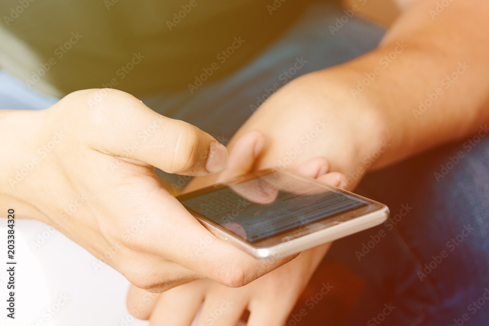 human hand holding smartphone. shopping concept. with sunlight human hand holding smartphone. shopping concept. with sunlight
