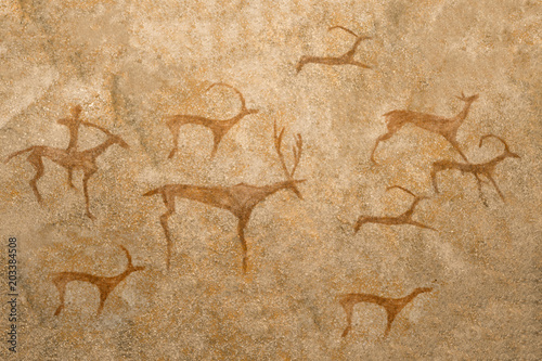 An ancient image of animals on a cave wall painted by an ancient man. history, archeology, antiquity.