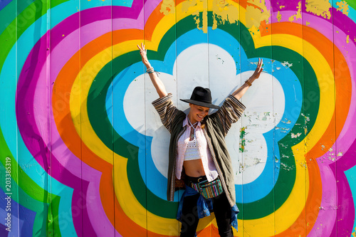 hipster girl standing in a colorfull background photo