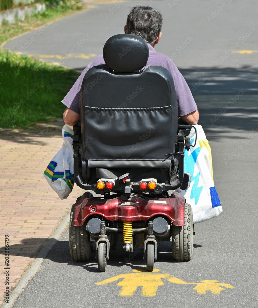 Man with electric wheelchair on the street