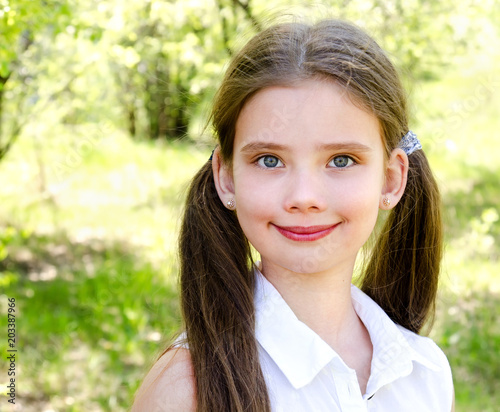 Portrait of adorable smiling little girl outdoors
