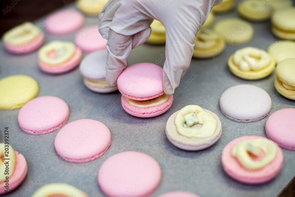 cooking, confectionery and baking concept - macarons on table cooking, confectionery and baking concept - macarons on table
