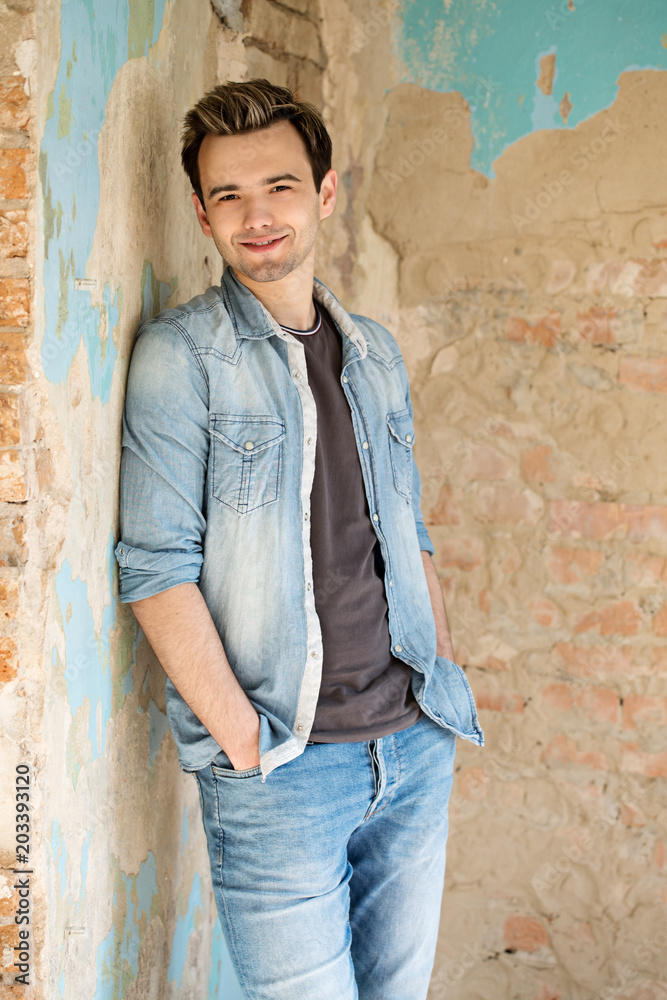 A man in jeans and a shirt A man in jeans and a shirt