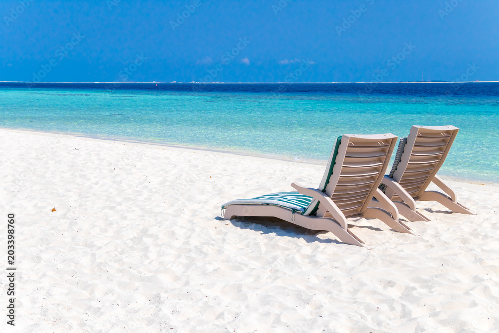 Beach chairs on tropical beach Beach chairs on tropical beach