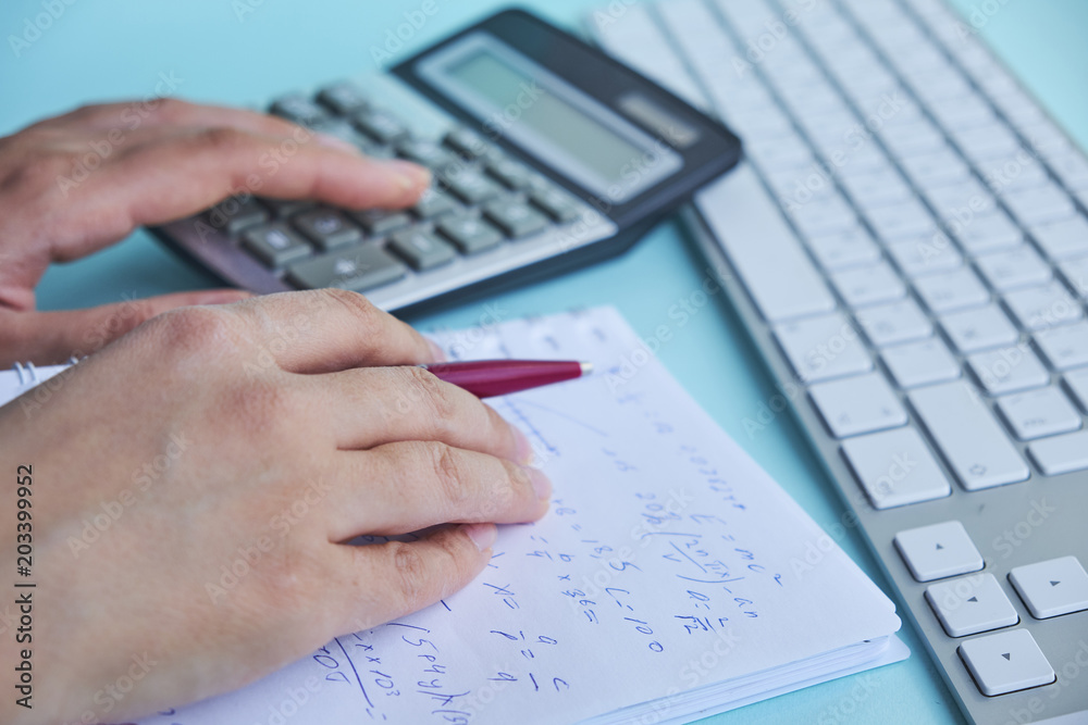 woman working with calculator, business document and laptop computer notebook woman working with calculator, business document and laptop computer notebook