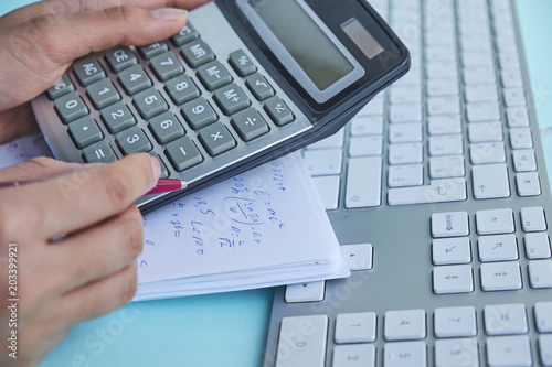 Business and finance concept.women work with calculator and laptop,pen and notebook on the wooden table