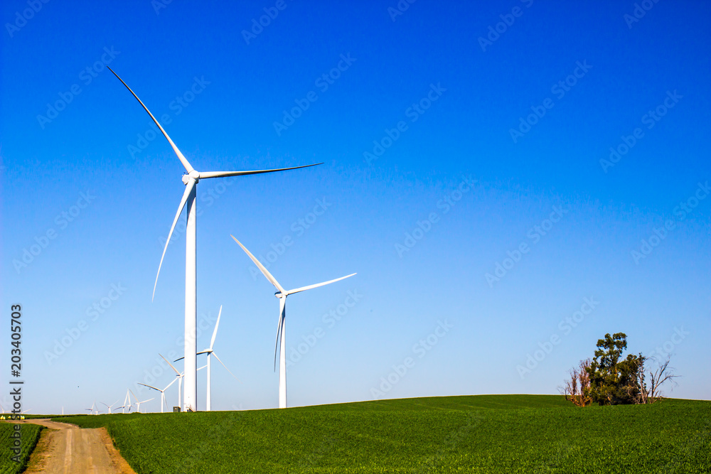 Energy Making Windmills On Hillside In Open Field Energy Making Windmills On Hillside In Open Field