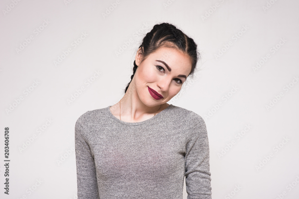 Portrait of a happy beautiful young brunette girl on a white background. Portrait of a happy beautiful young brunette girl on a white background.