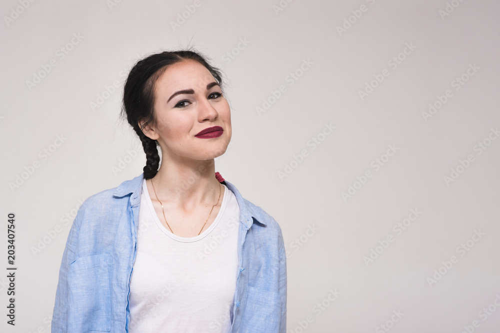 Portrait of a happy beautiful young brunette girl on a white background. Portrait of a happy beautiful young brunette girl on a white background.