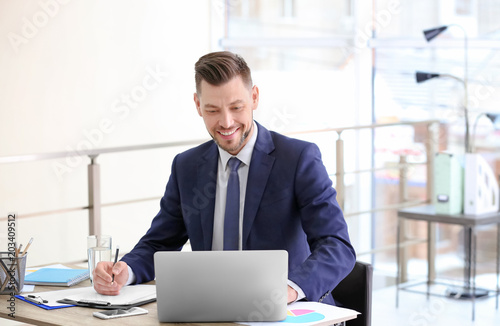 Consultant working at table in office photo