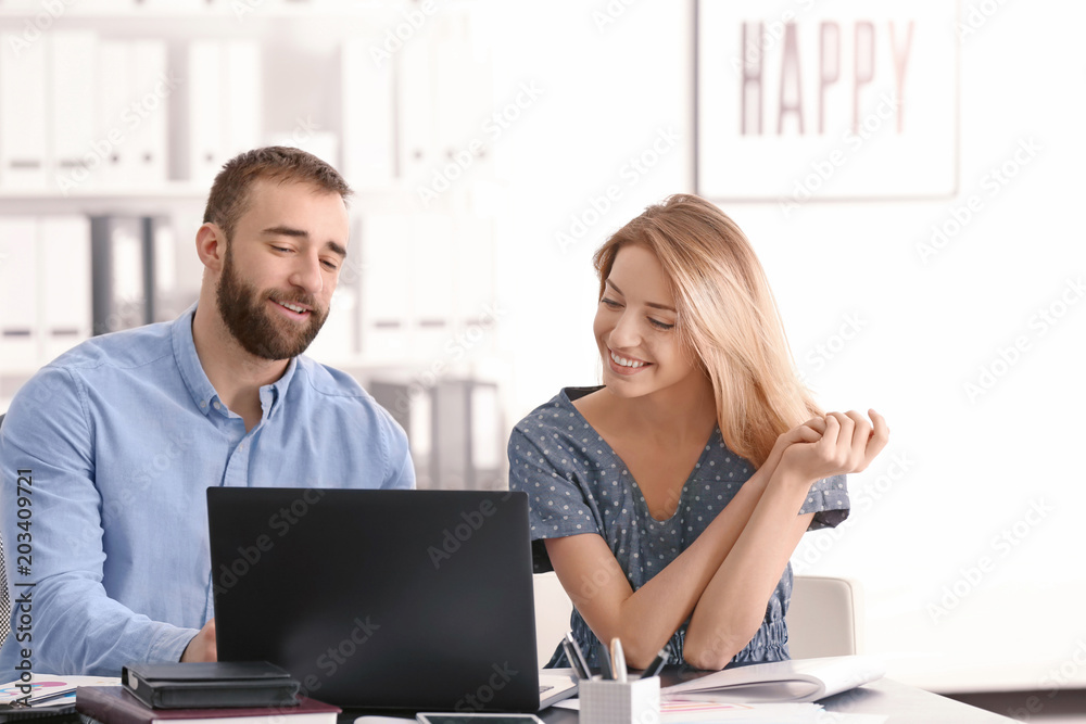 Businessman consulting young woman in office Businessman consulting young woman in office