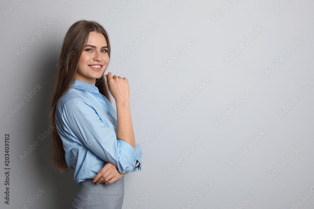 Beautiful real estate agent on grey background Beautiful real estate agent on grey background