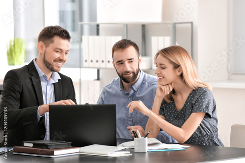 Businessman consulting young couple in office © Africa Studio